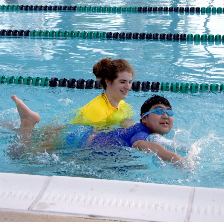 Adaptive swim program swimmer and coach in pool